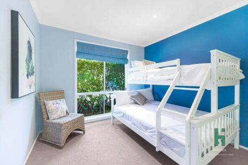 a bedroom with a white bunk bed and a window at Private Jetty Kayaks Pets allow WoyWoy Bay in Woy Woy