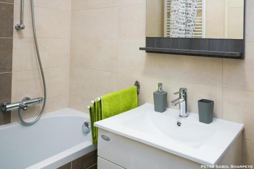 a bathroom with a sink and a shower at City break apartment in Čakovec