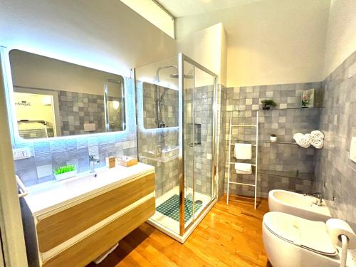 a bathroom with a shower and a tub and a toilet at Suite Sommeiller Comfort in centro in Turin