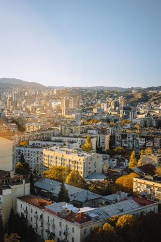 an aerial view of a city with buildings at Hotel Sky Station in Tbilisi City