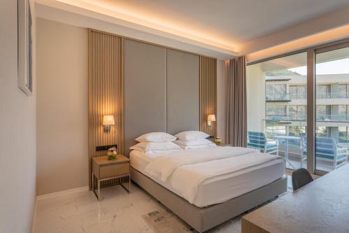a bedroom with a large bed and a balcony at Hyatt Regency Kotor Bay Resort in Kotor