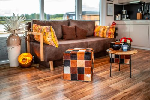 a living room with a couch and a table at Floatinghouses Bärwalder See in Klitten