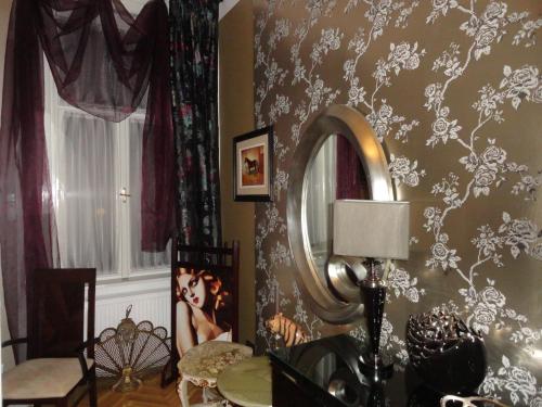 a living room with a mirror and a table at Boudoir Budapest Apartment in Budapest