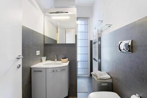 a bathroom with a sink and a toilet and a mirror at La casetta di Ale in La Spezia