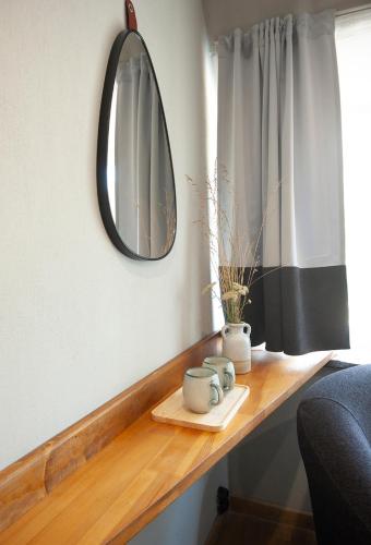 a mirror sitting on a wooden counter in a room at "Park Hotel Ela" in Borovets