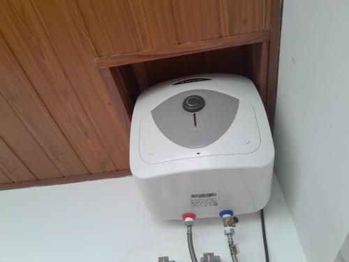 a paper towel dispenser in the corner of a cabinet at Creek View Inn in Nuwara Eliya