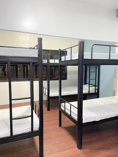 a group of bunk beds in a room at Lime Lite Manila Hostel in Manila