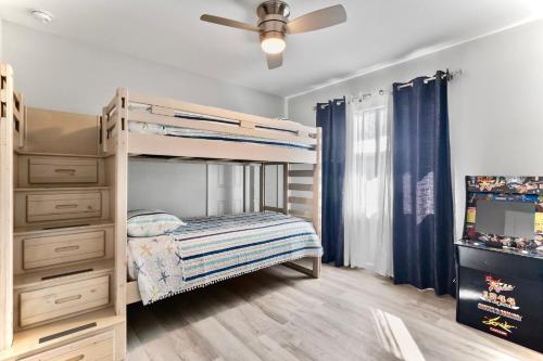 a bedroom with a bunk bed and a dresser at Everglade Kiss 3b 2b BBQ, hot tub in Port Charlotte