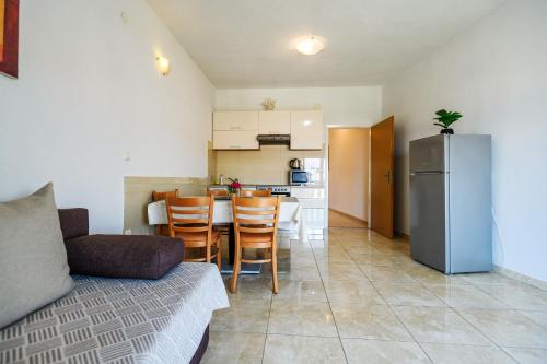 a living room with a couch and a kitchen at Apartman KALI in Kali