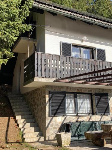 a house with a staircase and a balcony at Apartments Nune 2 in Zreče