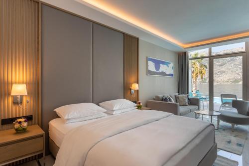 a bedroom with a large bed and a living room at Hyatt Regency Kotor Bay Resort in Kotor