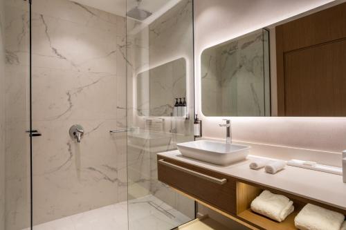 a bathroom with a sink and a shower at Hyatt Regency Kotor Bay Resort in Kotor