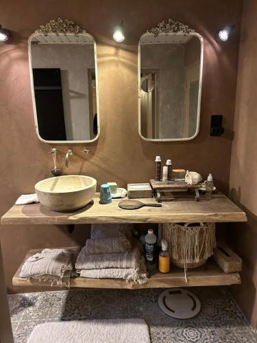a bathroom with a sink and two mirrors at Landgoed de Bongel in De Wijk