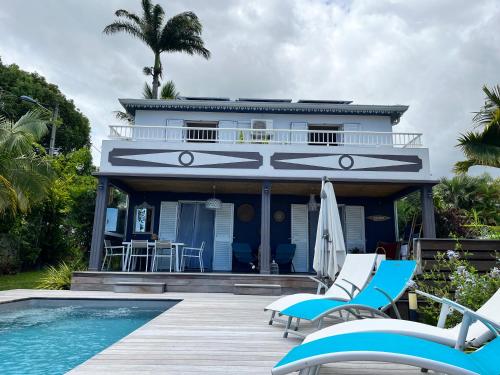 a house with a swimming pool next to a house at Villa Galabé et Tafia in Sainte-Marie
