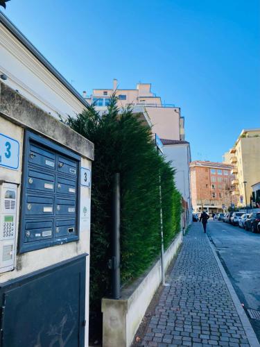 a street with a bush on the side of a building at Central Luxury Garden guest house in Mestre