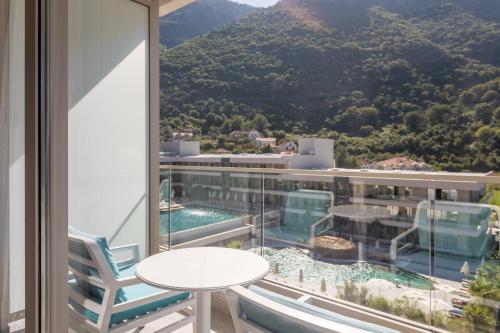 a balcony with a table and a view of a mountain at Hyatt Regency Kotor Bay Resort in Kotor