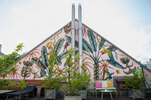 a mural on the side of a building with plants at Small Luxury Hotel Altstadt Vienna in Vienna