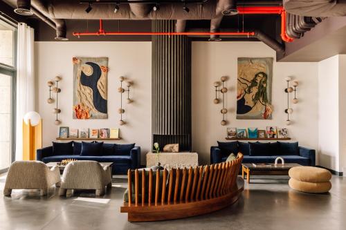 a living room with blue couches and a table at The Rebello Hotel & Spa - Small Luxury Hotels Of The World in Vila Nova de Gaia