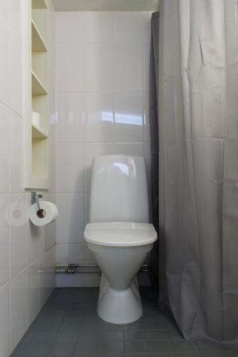 a bathroom with a toilet and a shower curtain at Chic Studio in Historic Kruununhaka, Helsinki in Helsinki