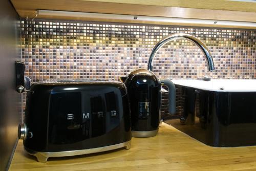 a toaster sitting on a kitchen counter next to a sink at Chic Studio in Historic Kruununhaka, Helsinki in Helsinki