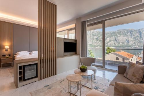 a living room with a couch and a fireplace at Hyatt Regency Kotor Bay Resort in Kotor