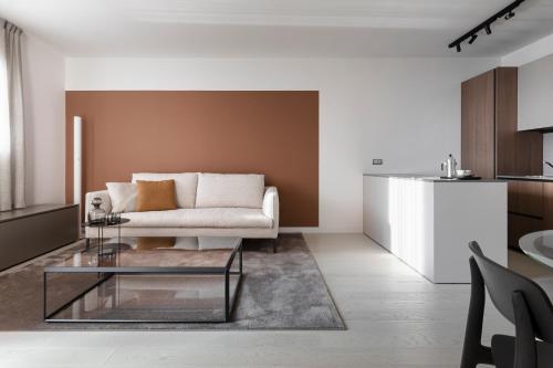 a living room with a couch and a table at Portopiccolo Apartments - Perla nel borgo in Sistiana
