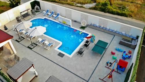 查普利納的住宿－Villa Deluxe BB，享有带桌椅的游泳池的顶部景致