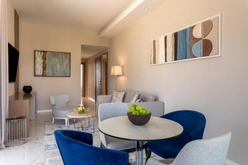 a living room with a couch and a table and chairs at Hyatt Regency Kotor Bay Resort in Kotor