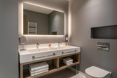 a bathroom with a sink and a mirror at Hyatt Regency Kotor Bay Resort in Kotor