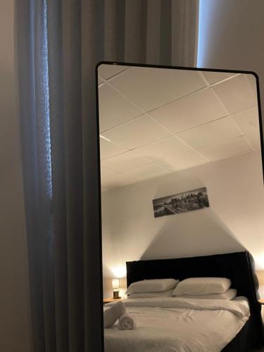 a mirror reflection of a bed in a bedroom at K.suites סוויטות בוטיק in Bet Sheʼan
