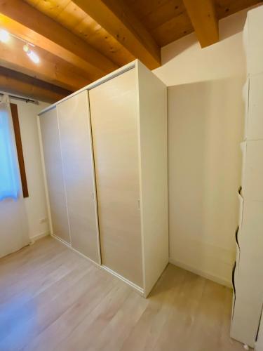 an empty room with white walls and wooden ceilings at Central Luxury Garden guest house in Mestre