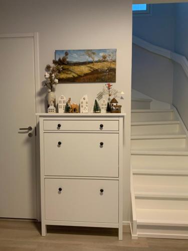 a white dresser in a room with a staircase at QnQ home stay - Private room in the shared detached house in Vantaa