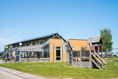 a building with a staircase and a playground at Camping Tussen de Diepen in Blokzijl