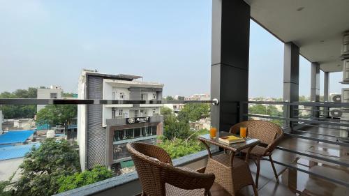 a balcony with a table and chairs on a building at BluO 1BHK Suite - Balcony, Lift, Gym, Parking in Gurgaon