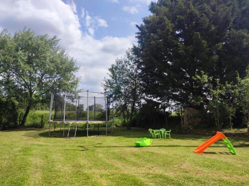 a park with a volley ball goal and an orange at Gîte La Pâquerie in Le Louroux-Béconnais