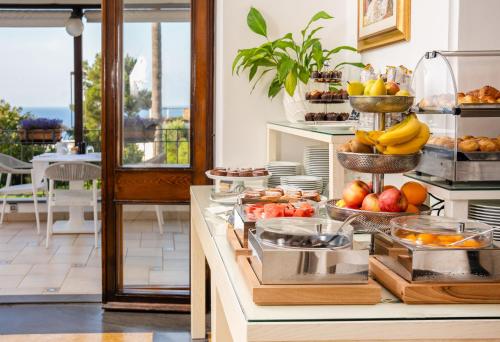 a buffet with fruit and other food on a table at Hotel Syrene in Capri