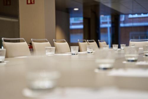 a long table with chairs and glasses on it at VP Madroño in Madrid