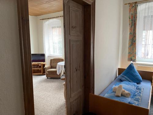 a bedroom with a bed with a teddy bear on it at Hotel Stadt Leipzig in Roßwein