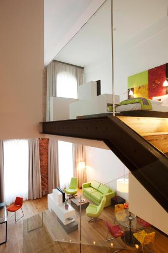 a room with a bed and a living room at Vienna House by Wyndham Andel's Lodz in Łódź