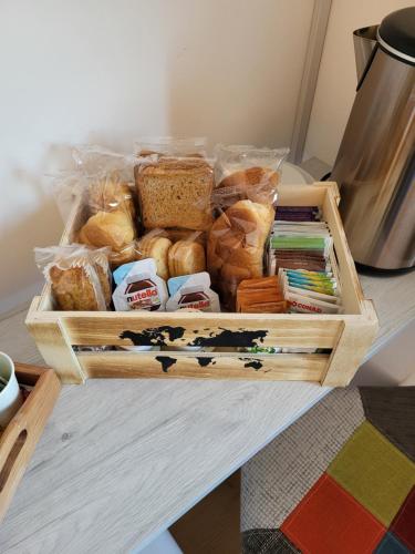 a crate of bread and pastries on a table at Di Gioia Home B&B in Cosenza