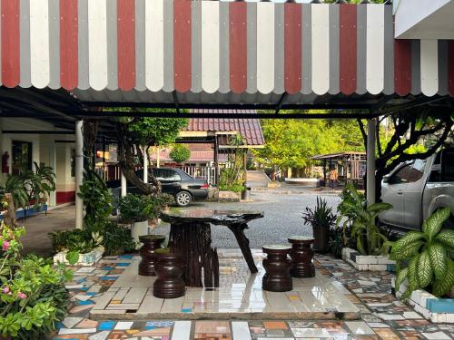 a patio with a table in the middle of a street at Suanpai Resort Sattahip in Sattahip