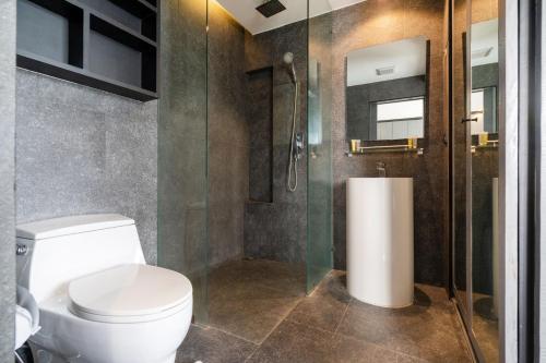 a bathroom with a toilet and a shower at Citygate Condo L704, near FantaSea & Café Del Mar Kamala Beach Club in Kamala Beach