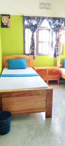 a bedroom with a wooden bed in a room at Hostel Kiliwood in Moshi