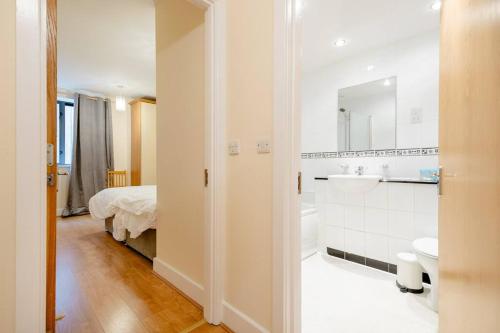 a white bathroom with a bed and a sink at Peaceful 2 bedrooms near St Patrick's Cathedral in Dublin