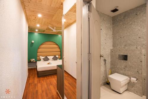 um quarto com uma cama e uma parede verde em Zostel Mussoorie (Mall Road) em Mussoorie
