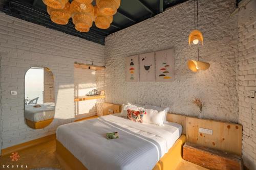 a bedroom with a large bed and a bathroom at Zostel Mussoorie (Mall Road) in Mussoorie