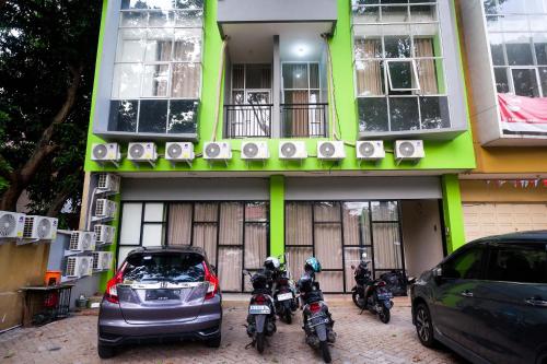 a group of motorcycles parked in front of a building at Urbanview Hotel AVA Semarang near Akademi Kepolisian Semarang by RedDoorz in Jatingaleh