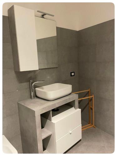 a bathroom with a sink and a mirror at Domeanto home in Catania