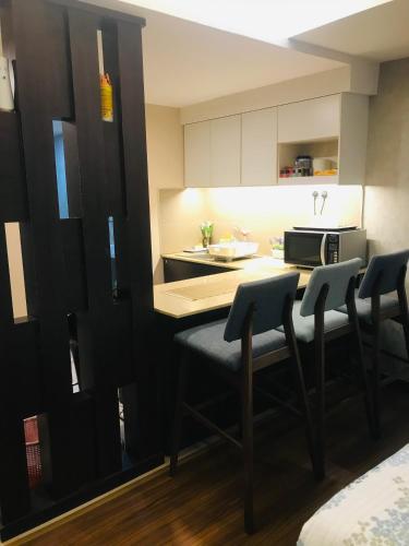 a kitchen with a table and chairs in a room at FirIzzkey Studio in Kota Bharu