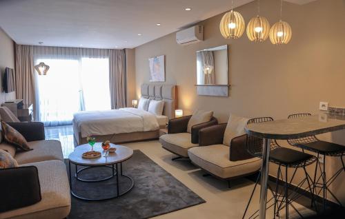 a living room with a couch and a bed at PLAYA DEL PACHA Suites Hotel in Marina Smir